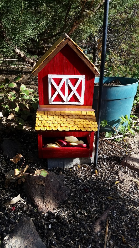 Snack Box...was old, plain, and falling apart. I painted it, made fake doors, put shingles on roof...now it is beautiful. The raccoons like to take the roof off to see what is in there.
